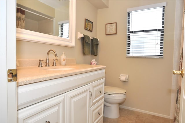 bathroom with toilet, tile patterned floors, and vanity