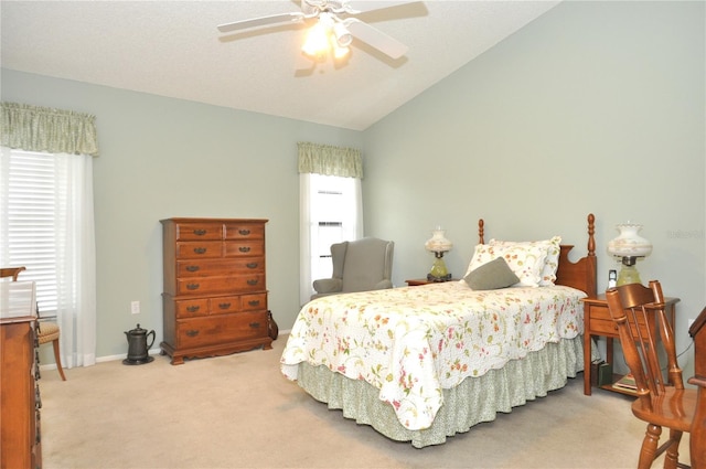 carpeted bedroom with ceiling fan and lofted ceiling