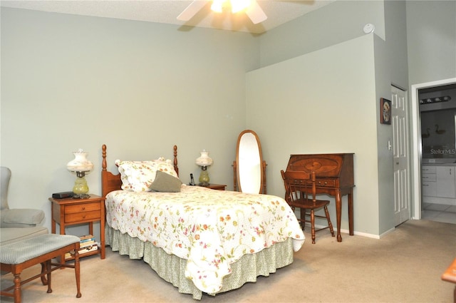 bedroom with ceiling fan, carpet, ensuite bathroom, and a closet