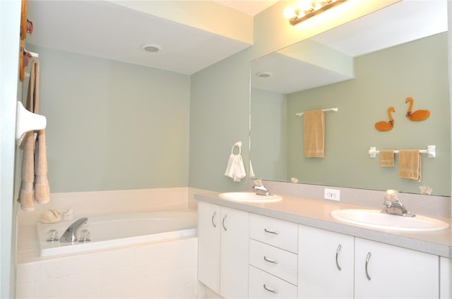 bathroom featuring vanity and a relaxing tiled tub