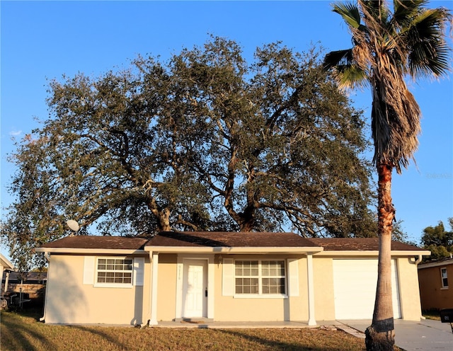 ranch-style house featuring a front lawn and a garage