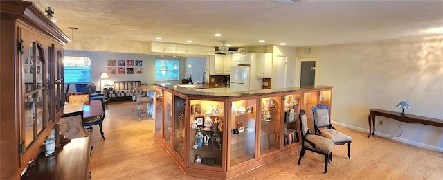 kitchen featuring ceiling fan, light hardwood / wood-style floors, white fridge, and pendant lighting