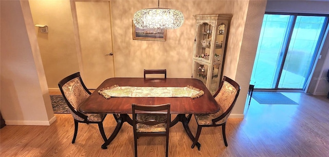 dining space featuring hardwood / wood-style flooring and a healthy amount of sunlight