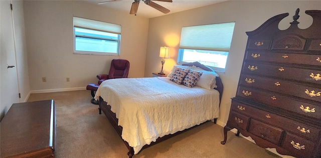 bedroom with ceiling fan, carpet floors, and multiple windows