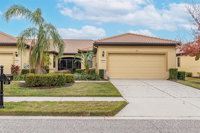 mediterranean / spanish-style house with a front yard and a garage