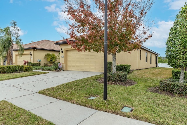 view of front of home featuring a garage and a front lawn