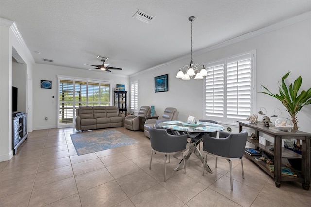 dining area with light tile patterned floors, crown molding, and ceiling fan with notable chandelier