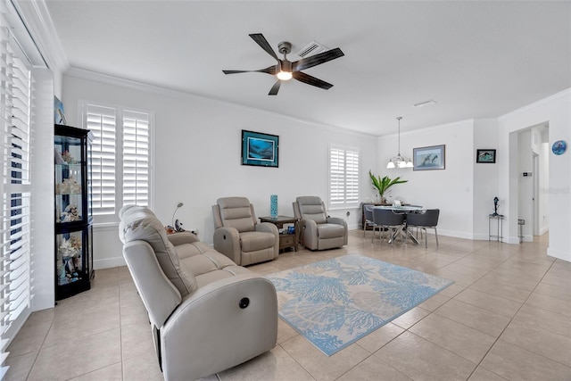 living room with a wealth of natural light, ceiling fan with notable chandelier, light tile patterned flooring, and crown molding