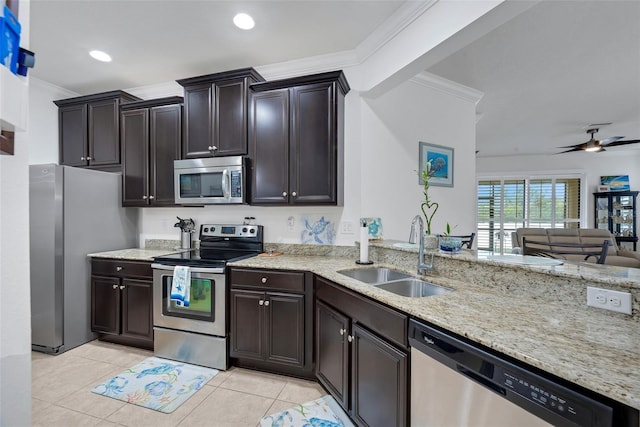 kitchen with stainless steel appliances, sink, ornamental molding, light tile patterned flooring, and ceiling fan