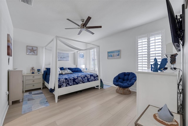 bedroom with ceiling fan and light hardwood / wood-style flooring