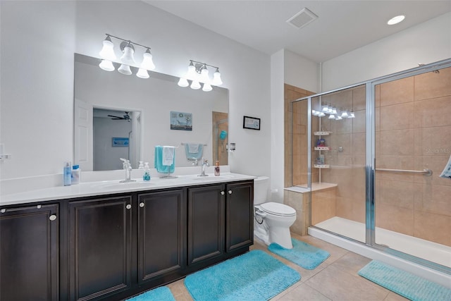 bathroom with toilet, tile patterned flooring, walk in shower, and vanity