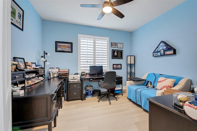 home office featuring light hardwood / wood-style floors and ceiling fan