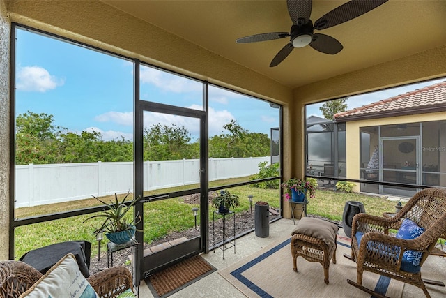 sunroom / solarium featuring ceiling fan