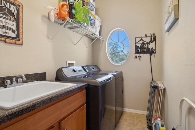 clothes washing area with sink, washer and clothes dryer, radiator heating unit, and light tile patterned floors