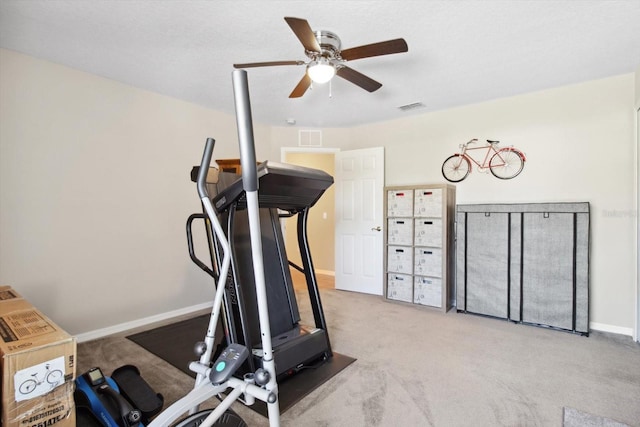 workout room with ceiling fan and light carpet