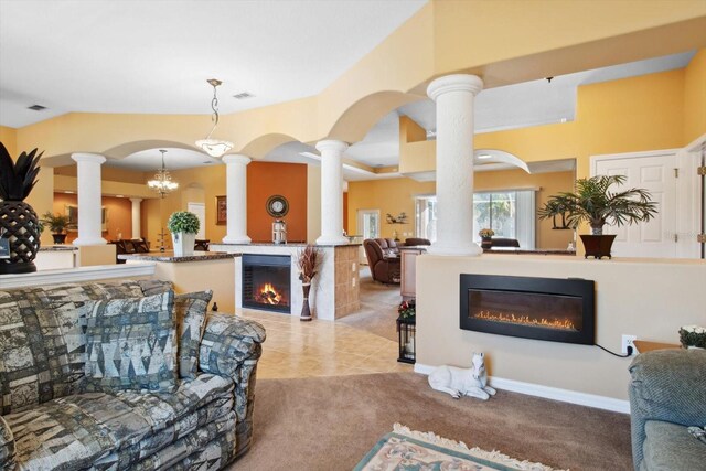 living room with a notable chandelier and light colored carpet