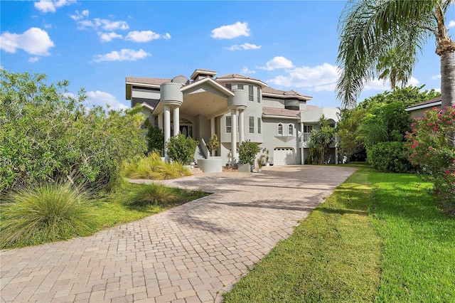 view of front of property with a garage and a front lawn