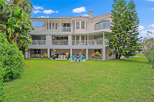 rear view of property with a patio area and a lawn