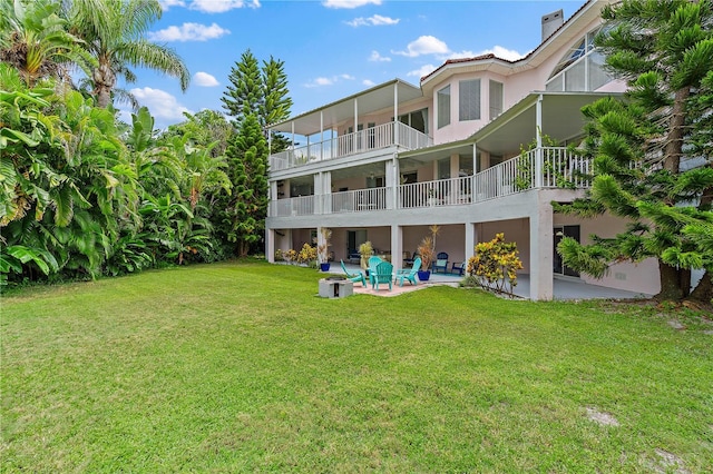 back of house featuring a patio and a yard