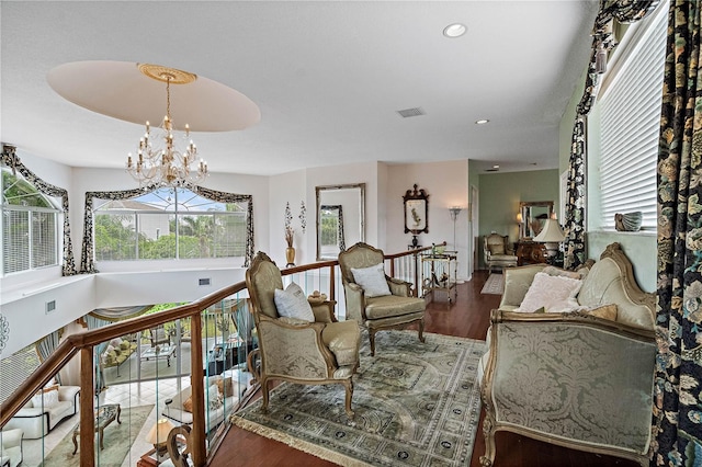 living room with wood-type flooring and an inviting chandelier