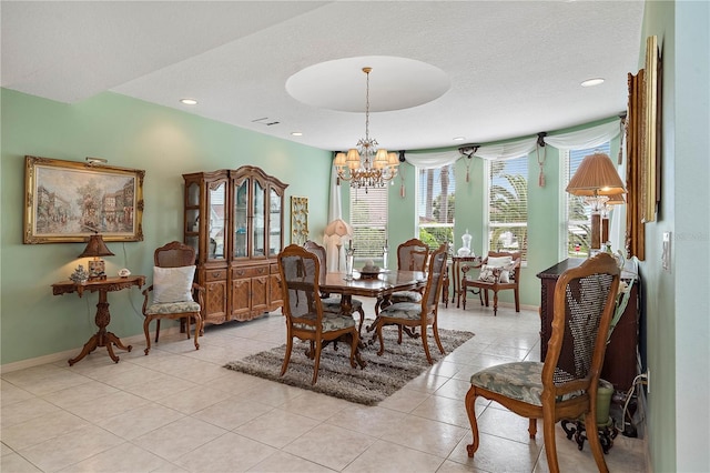 dining area with light tile patterned floors and a notable chandelier