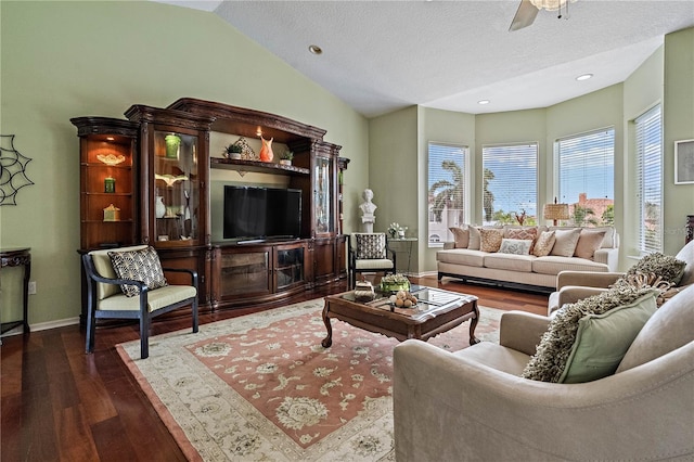 living room with ceiling fan, a textured ceiling, dark hardwood / wood-style floors, and vaulted ceiling