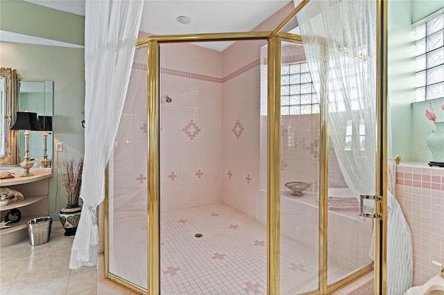 bathroom with a shower with shower door and tile patterned floors