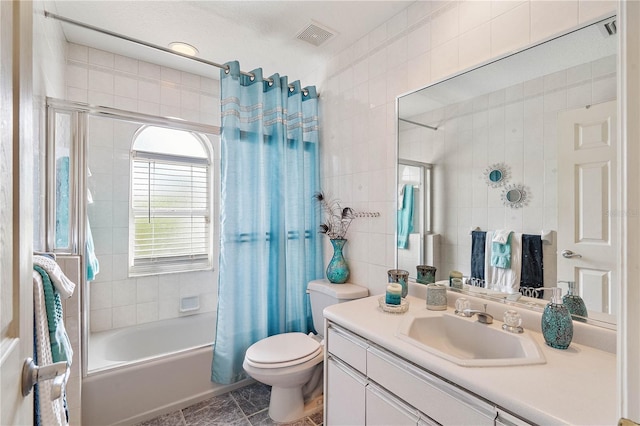 full bathroom featuring toilet, shower / tub combo with curtain, tile walls, tile patterned flooring, and vanity