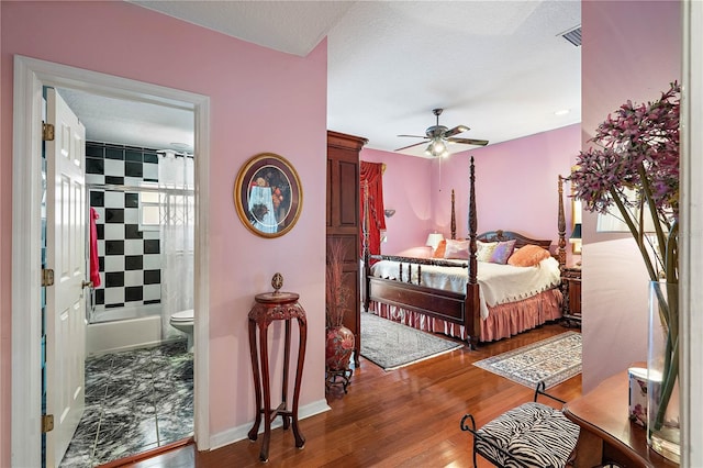 bedroom with ceiling fan, wood-type flooring, and connected bathroom