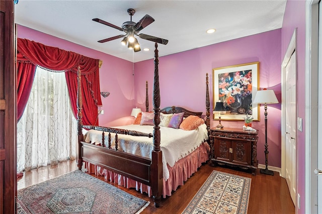 bedroom with ceiling fan and dark hardwood / wood-style flooring