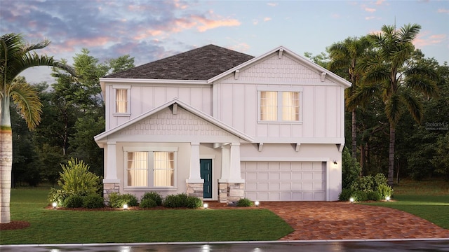 craftsman-style house featuring a yard and a garage