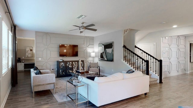 living room with ceiling fan and a healthy amount of sunlight