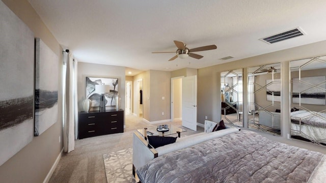 carpeted bedroom featuring a textured ceiling and ceiling fan