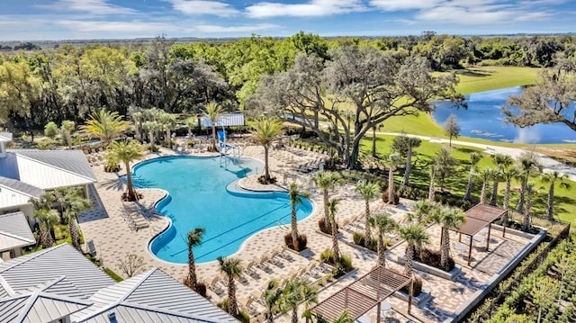 view of swimming pool with a patio and a water view