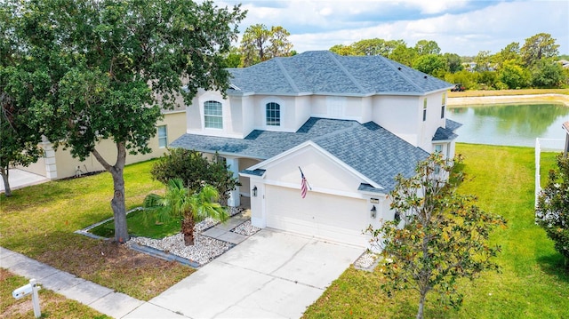 view of front of property featuring a water view, a garage, and a front lawn