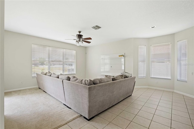 living room with light tile patterned floors and ceiling fan