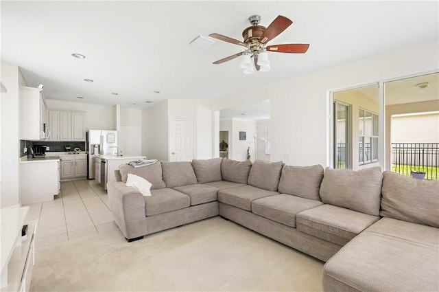 living room featuring light tile patterned floors and ceiling fan