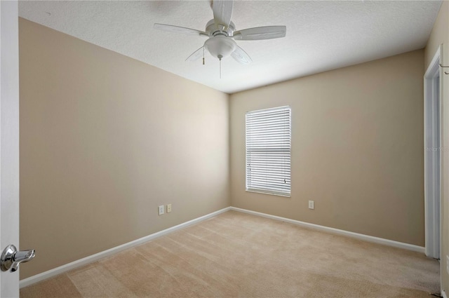 empty room featuring light carpet and ceiling fan