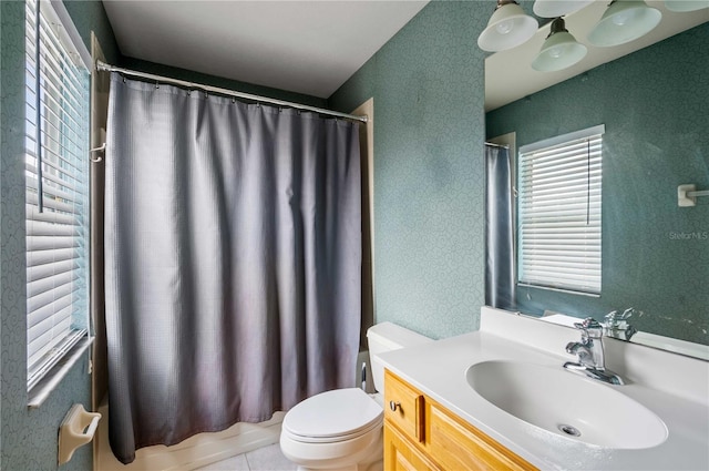 full bathroom with tile patterned flooring, vanity, shower / bath combo, and toilet