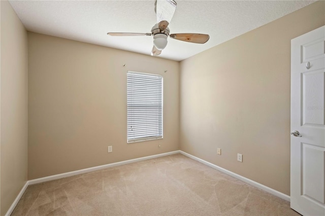 carpeted empty room featuring a textured ceiling and ceiling fan