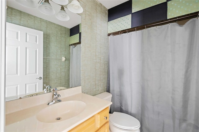 bathroom with walk in shower, vanity, and toilet