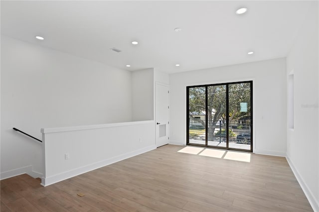 spare room with light hardwood / wood-style floors