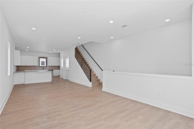 unfurnished living room featuring light hardwood / wood-style flooring