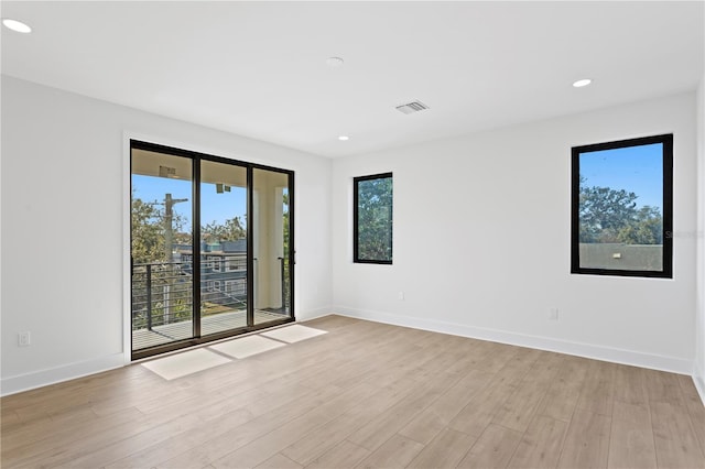 empty room with light wood-type flooring and a healthy amount of sunlight