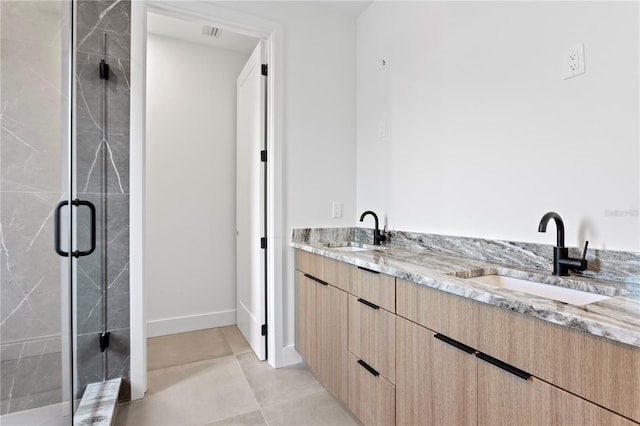 bathroom featuring tile patterned floors, vanity, and a shower with shower door