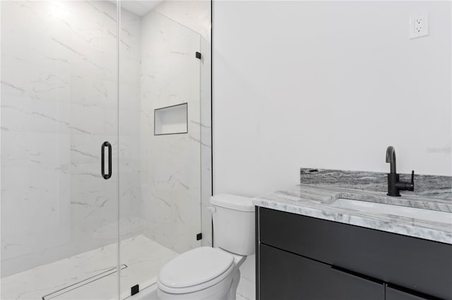 bathroom featuring a shower with door, vanity, and toilet