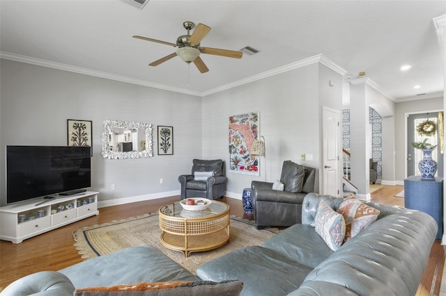 living room with ceiling fan, wood-type flooring, and ornamental molding