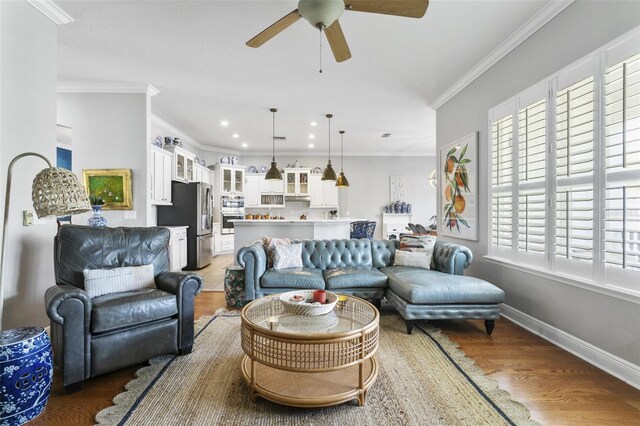 living room with ceiling fan, crown molding, and hardwood / wood-style floors