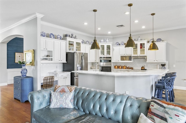 kitchen with dark hardwood / wood-style floors, tasteful backsplash, decorative light fixtures, crown molding, and white cabinets