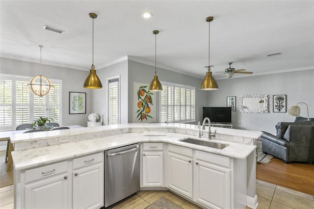 kitchen with stainless steel dishwasher, light tile patterned floors, sink, and white cabinetry